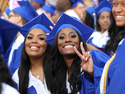  Two graduates smiling at camera